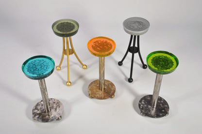 Set of five colorful stools with unique designs on a white background