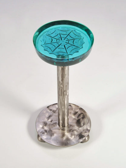 Bar stool with teal top and metal base on a white background