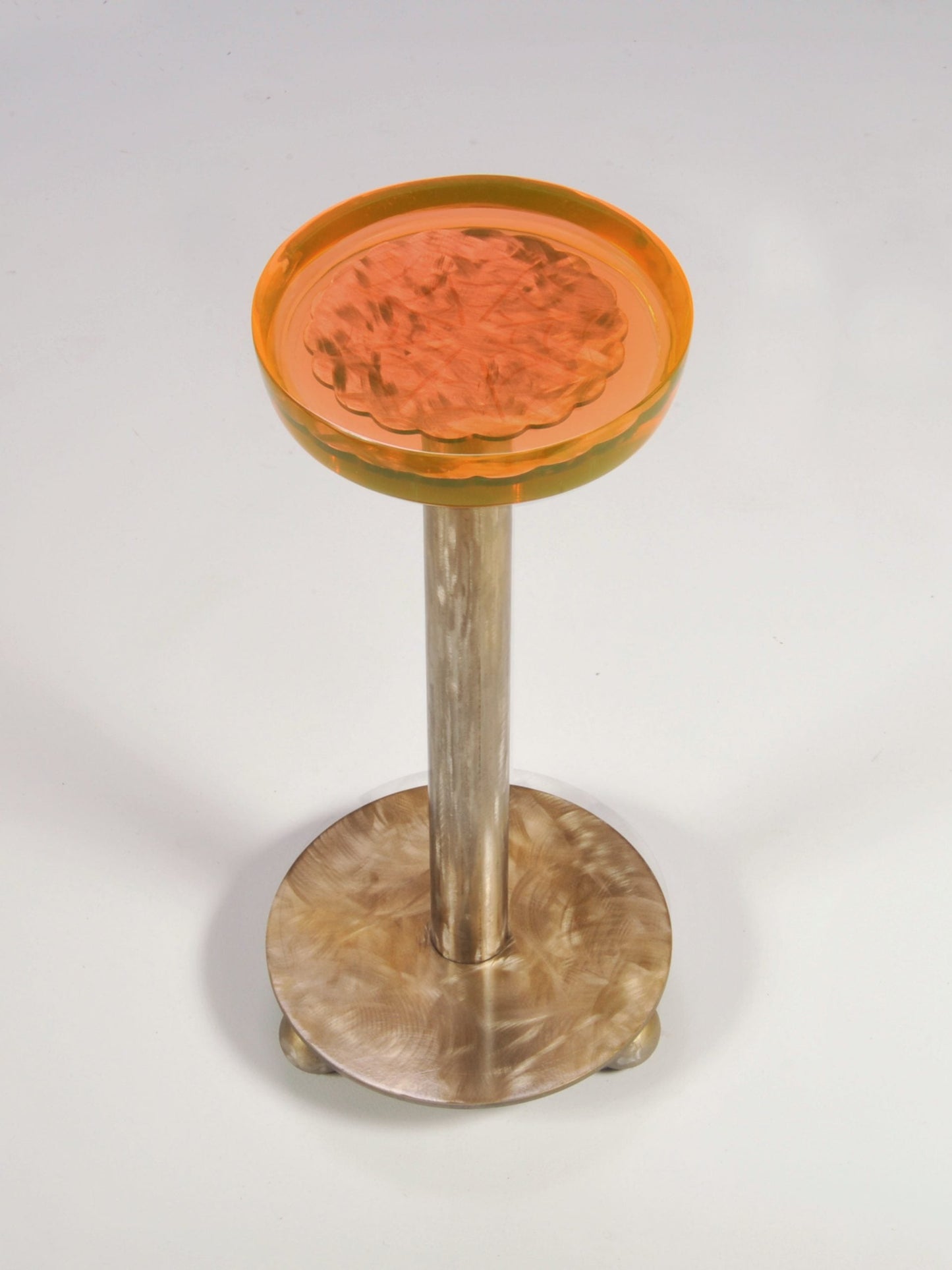 Decorative stool with a wooden base and orange top on a white background