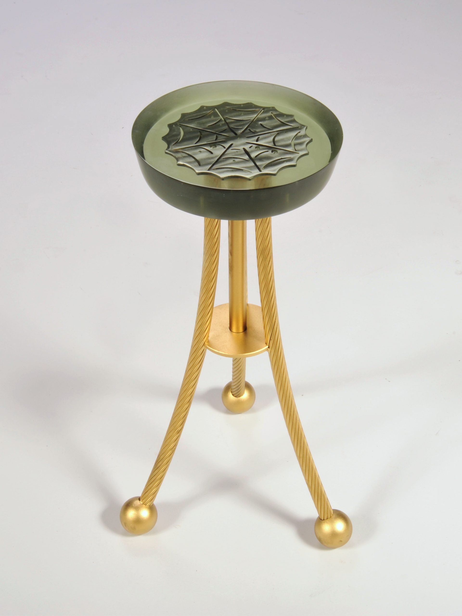 Stool with green top and gold legs on a white background