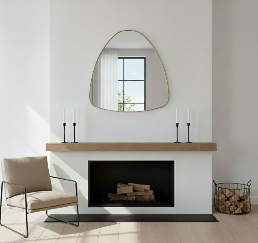 Soft pebble triangle mirror styled above modern fireplace mantel