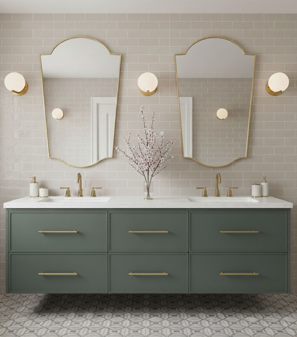 Pair of rounded crest brass mirrors in double vanity bathroom setting