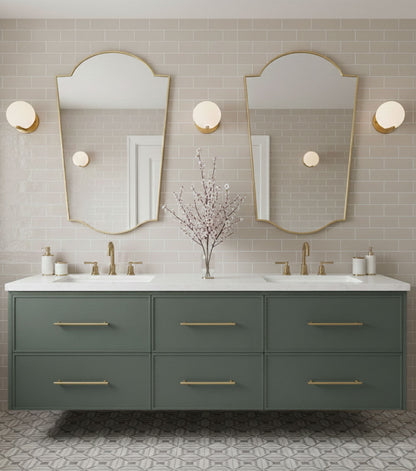 Pair of rounded crest brass mirrors in double vanity bathroom setting