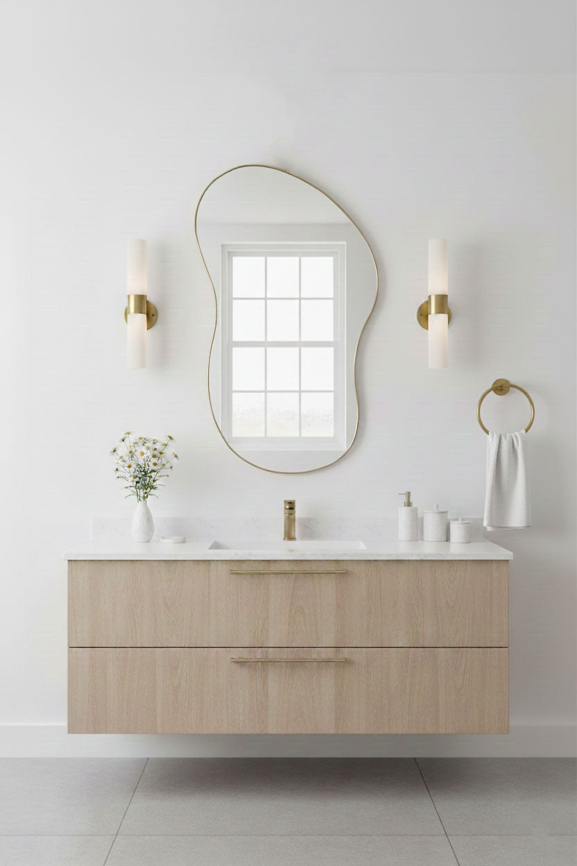 Organic freeform brass mirror in bright modern bathroom setting