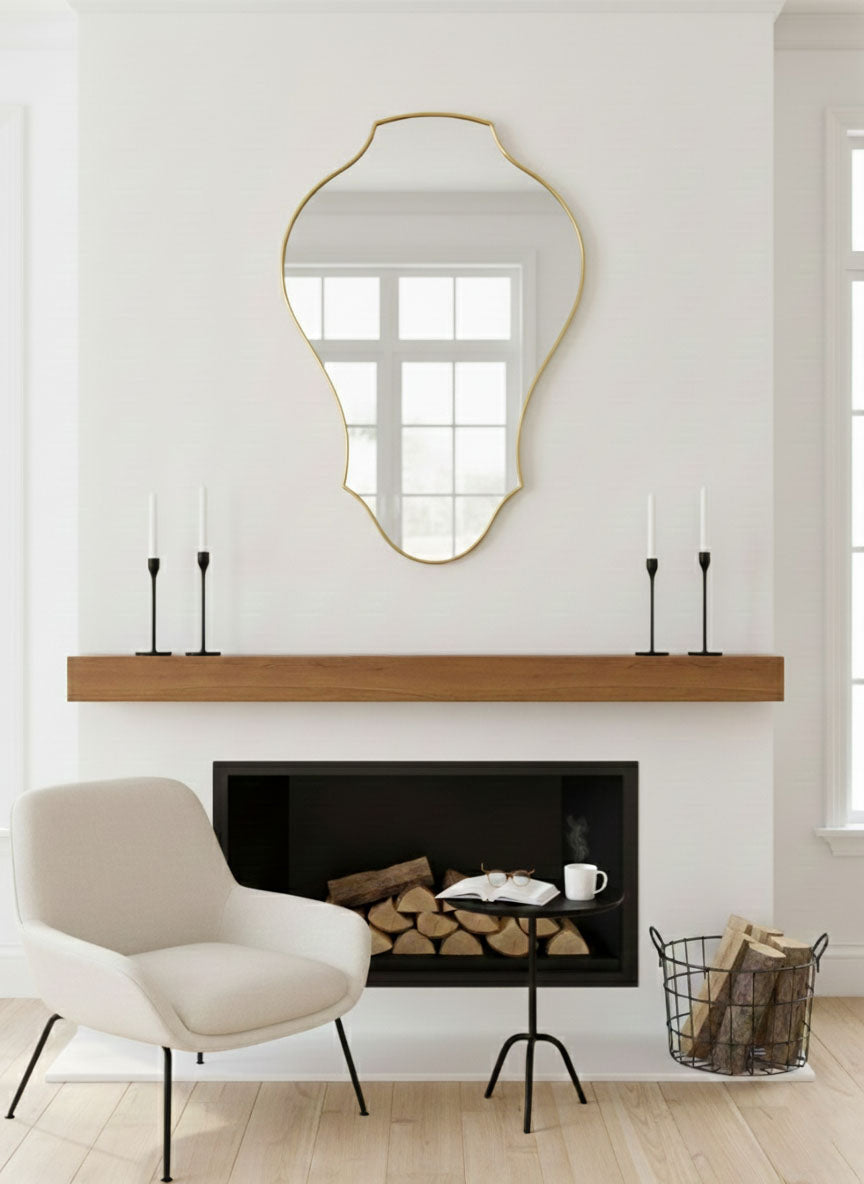 Handmade tulip shield mirror displayed above modern fireplace mantel