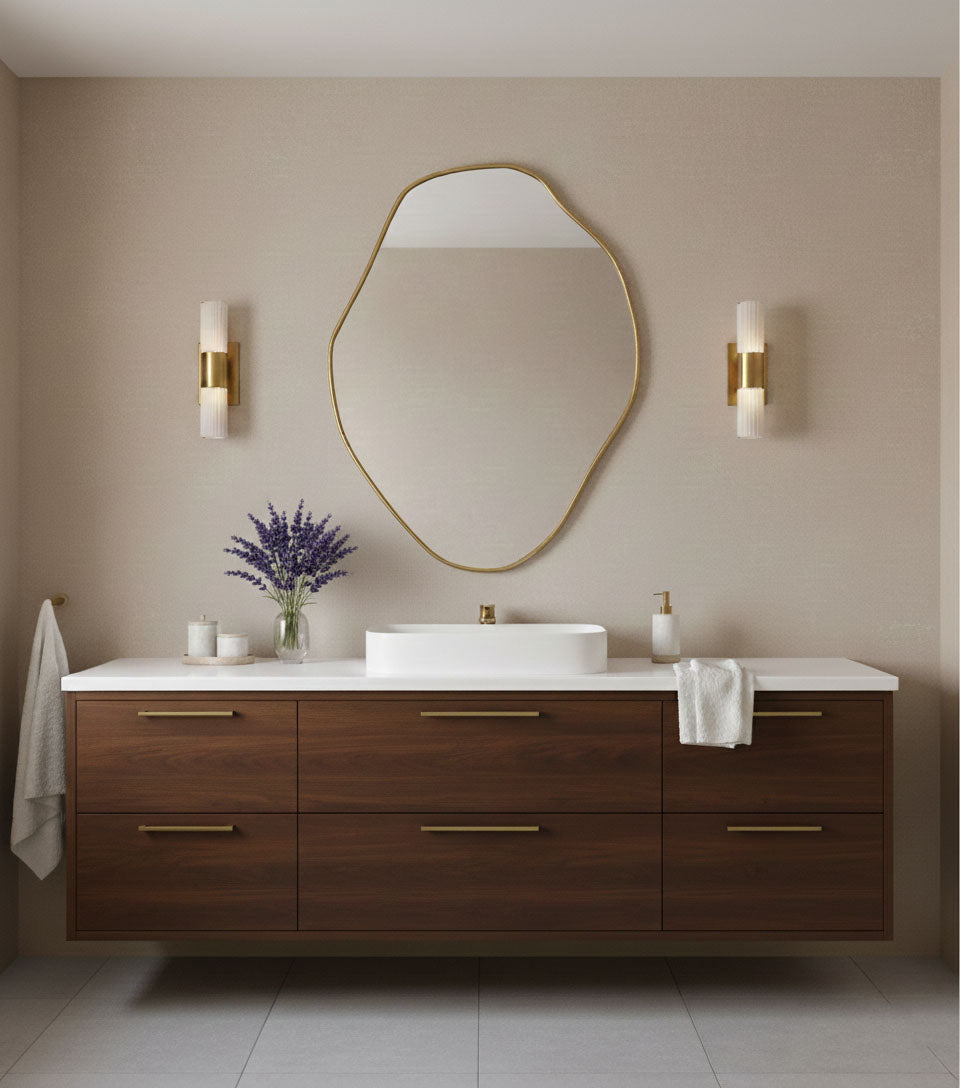 Organic freeform brass mirror styled above wooden vanity in modern bathroom