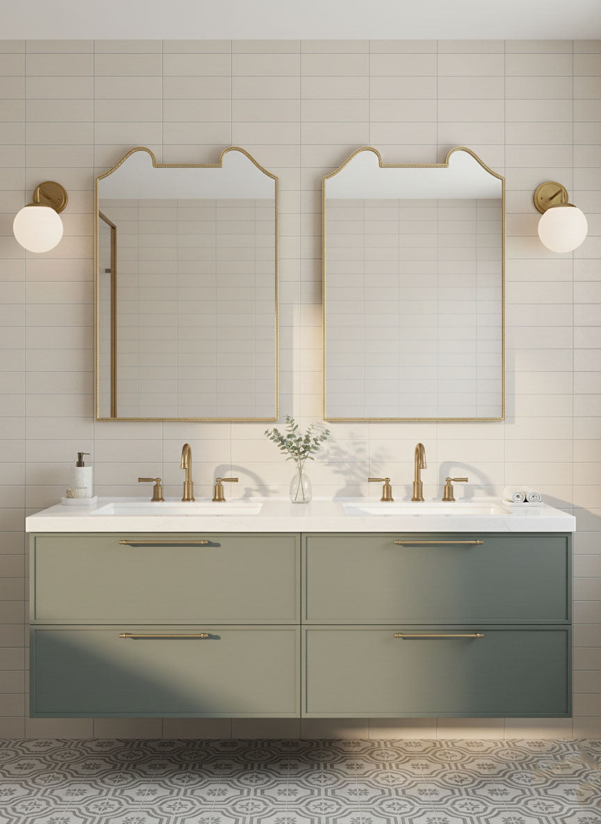 Pair of double arch crest brass mirrors over double vanity