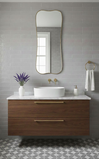 Belle Curve curved rectangle brass mirror over bathroom vanity