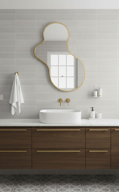 Organic amoeba mirror with brass frame in a modern bathroom