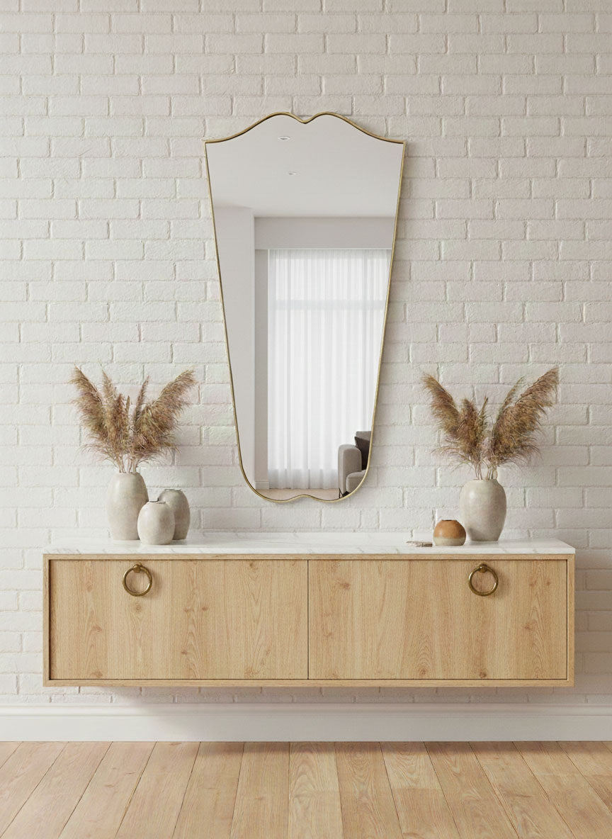Decorative Gentle Wave Crest brass mirror styled in neutral interior