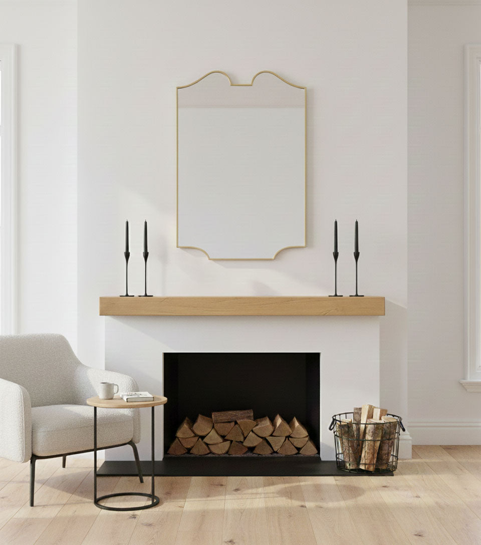 Handmade twin-curve crest mirror styled over fireplace mantel