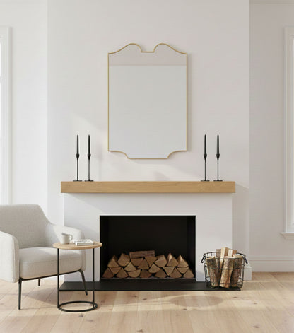 Handmade twin-curve crest mirror styled over fireplace mantel