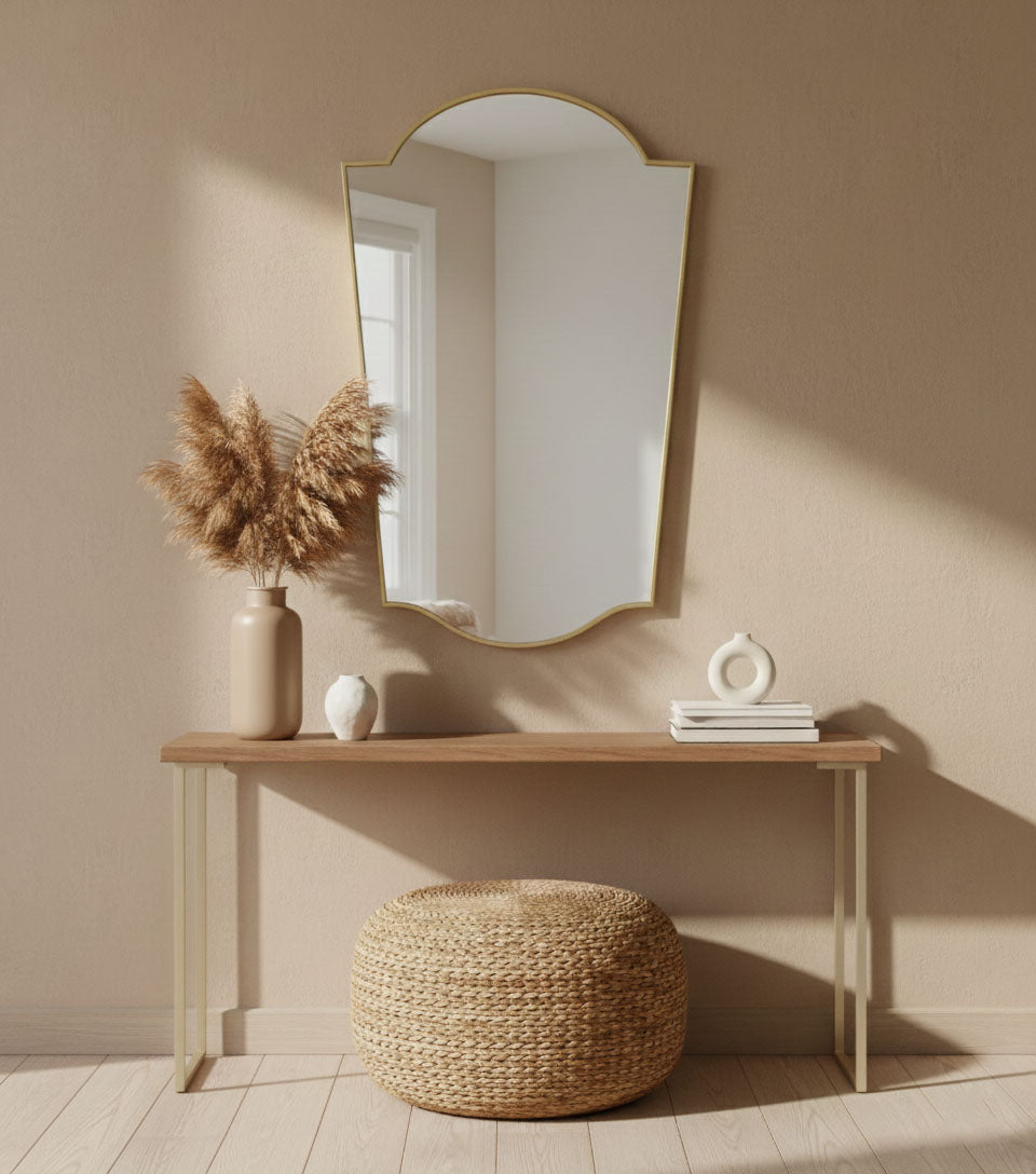 Rounded crest wall mirror styled above console table in minimal interior
