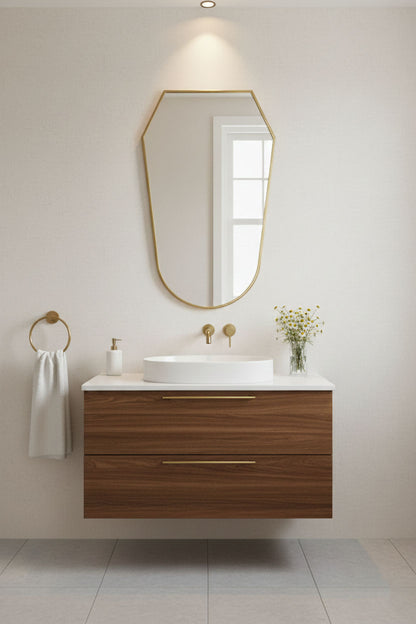 Modern rounded shield brass mirror above bathroom sink with wall sconces