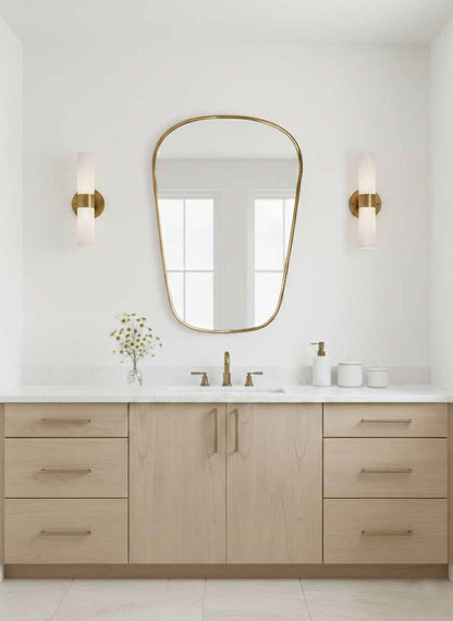 Modern brass wall mirror in bright minimalist bathroom