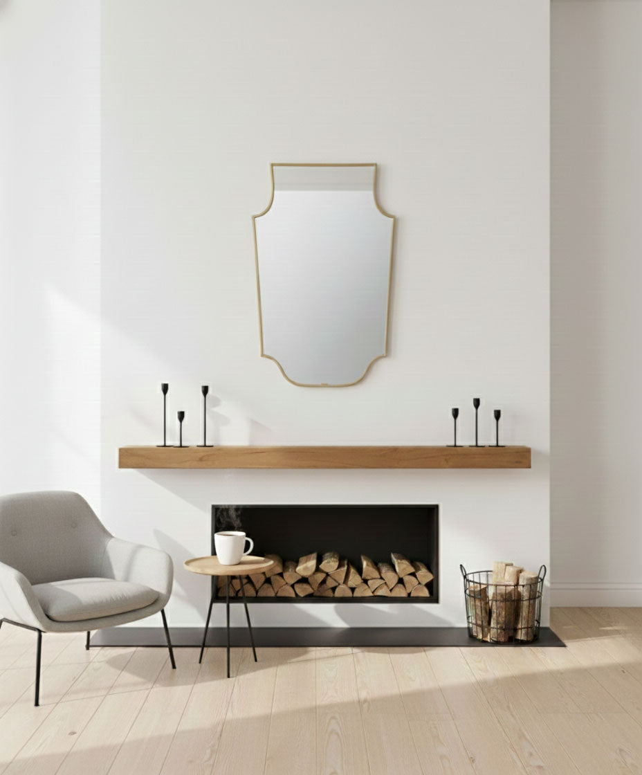 Grand Chateau brass crest mirror over fireplace