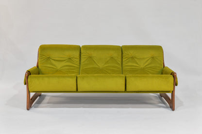 Green sofa with wooden frame on a white background