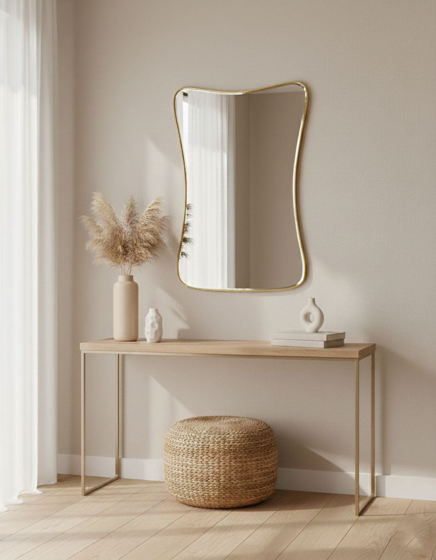 Cloud Curve Rectangle brass mirror styled above console table in warm modern interior