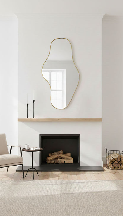 Asymmetrical Waveform brass mirror mounted above fireplace mantel