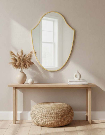 Gold framed sculpted wall mirror