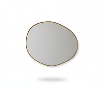 Raw edge brass mirror isolated on white background showing organic shape