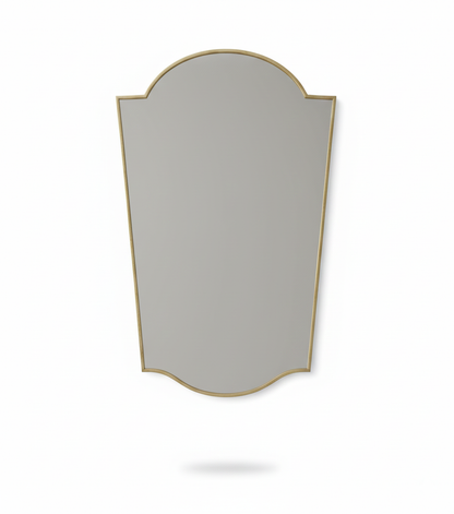 Studio shot of rounded crest brass mirror with curved top silhouette