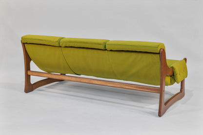 Green sofa with wooden frame on a white background