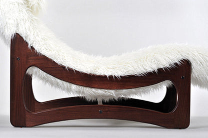 Wooden pet bed with white fur on a light gray background