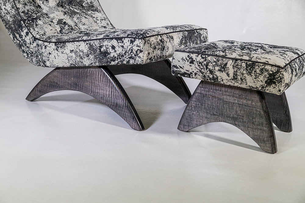Modern chair and ottoman set with marble-like pattern on a white background