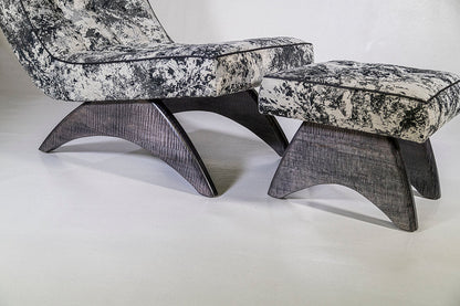 Modern chair and ottoman set with marble-like pattern on a white background