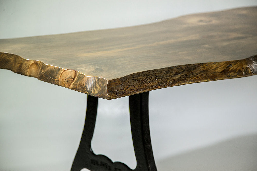 Wooden table with black metal legs on a white background