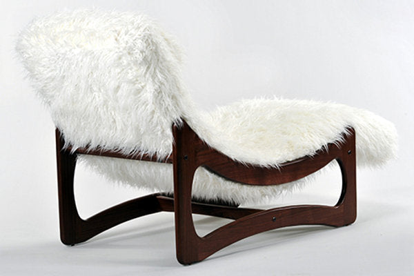 Chair with white fur cover on a light gray background