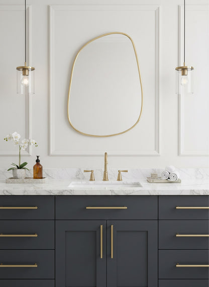 Bathroom vanity with dark gray cabinets, white countertop, and gold fixtures.