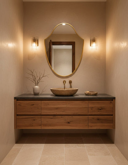 Bathroom vanity with wooden cabinet, round mirror, and sink.