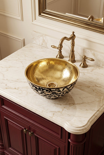 Brass and bone inlay vessel sink on cream marble above burgundy cabinetry, paired with a vintage brass faucet.