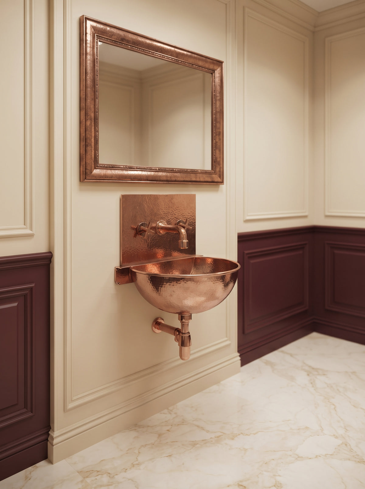 Copper wall-mounted sink with rectangular backsplash and exposed drainpipe beneath a copper-framed mirror in a cream and burgundy paneled bathroom.