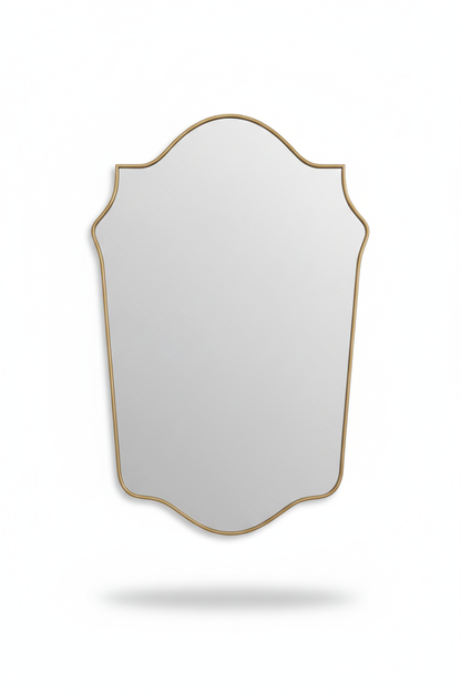 Elegant shield-shaped brass mirror with slim gold frame on white background
