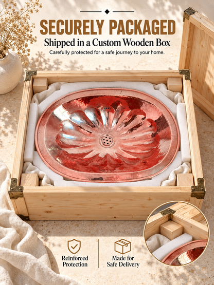 Oval copper sink with hammered flower-petal detailing protected by fitted foam in a wooden shipping box, with text highlighting secure packaging and safe delivery.
