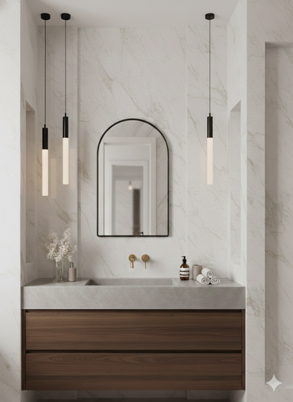 Modern bathroom with wooden vanity, marble countertop, and pendant lights.
