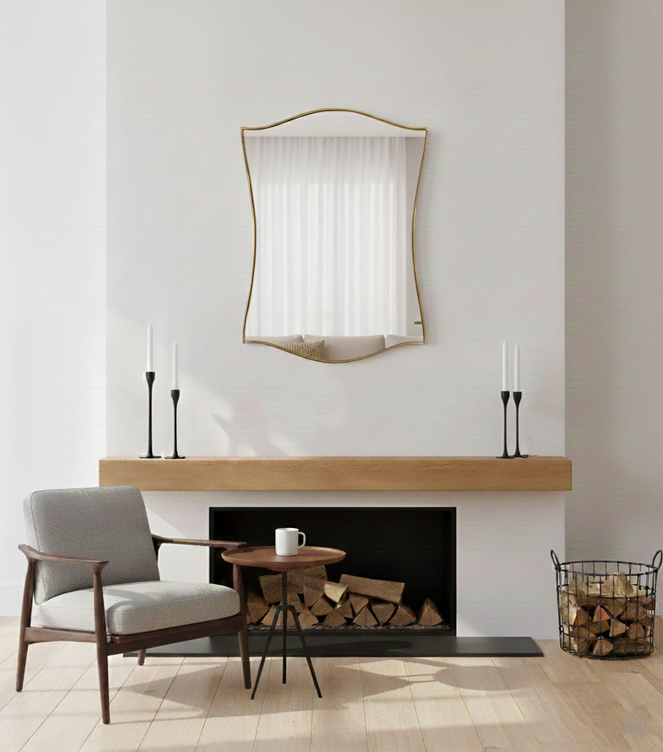 Graceful shield wall mirror styled above fireplace in modern living room