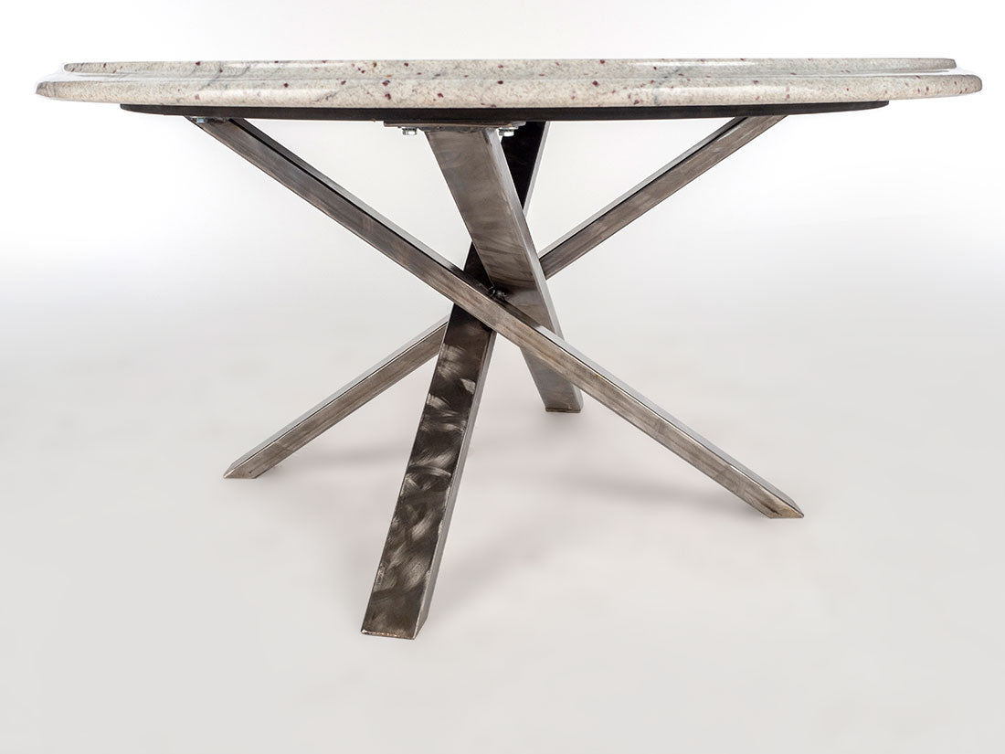 Dining table with marble-like top and metal X-shaped legs on a white background