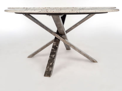 Dining table with marble-like top and metal X-shaped legs on a white background