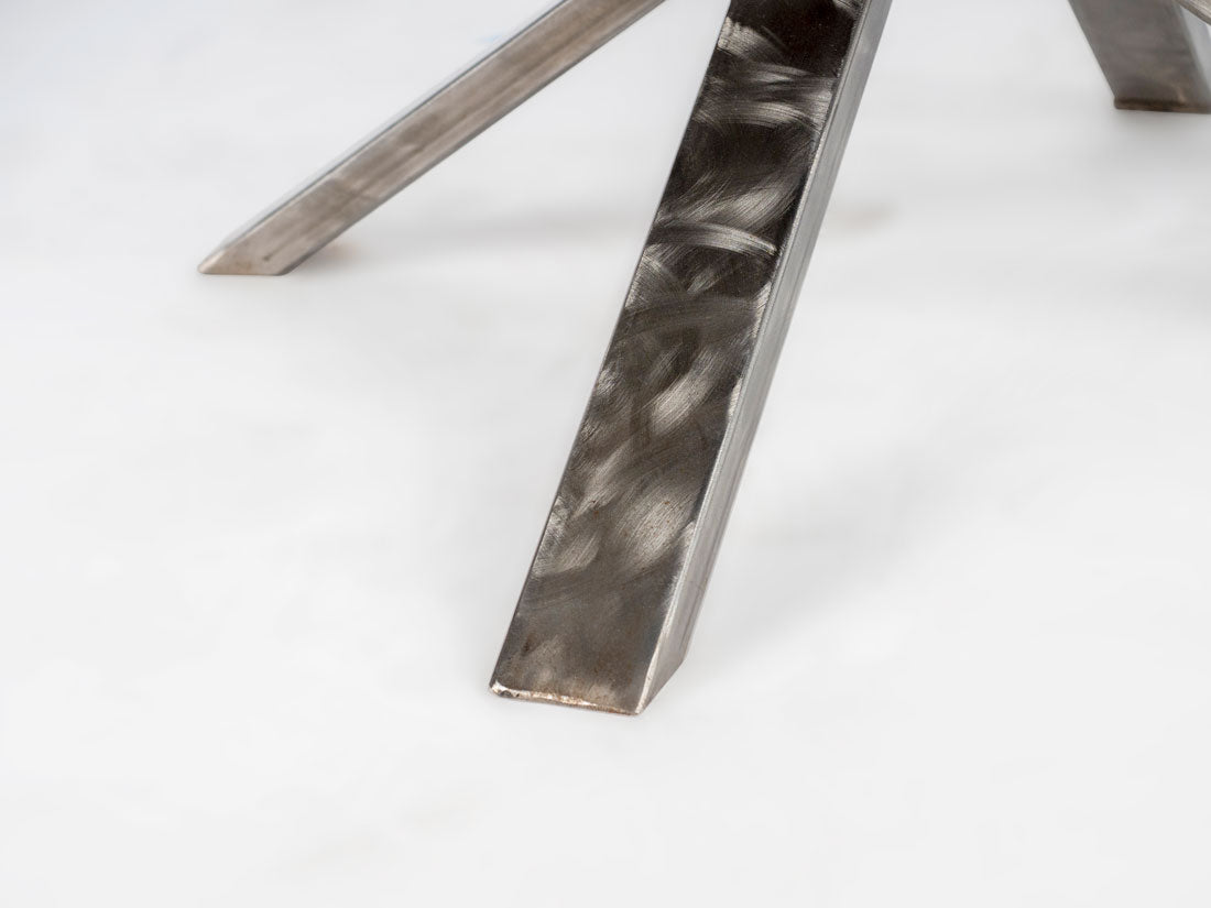 Close-up of a metallic chair leg on a white background