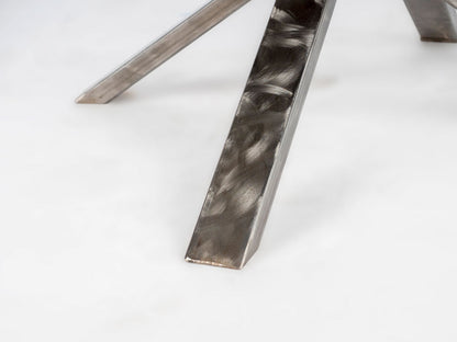 Close-up of a metallic chair leg on a white background