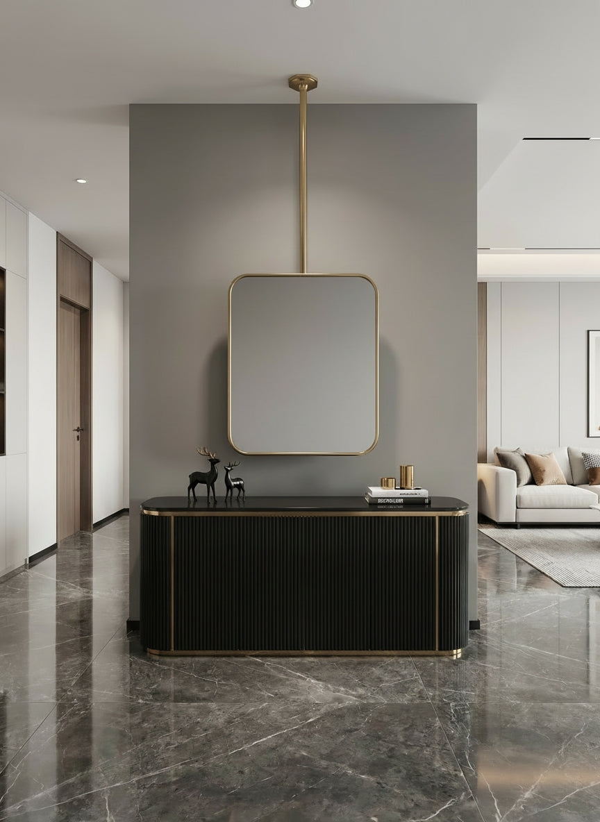 Rounded rectangle hanging brass mirror in a modern hallway interior