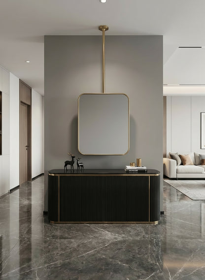 Rounded rectangle hanging brass mirror in a modern hallway interior