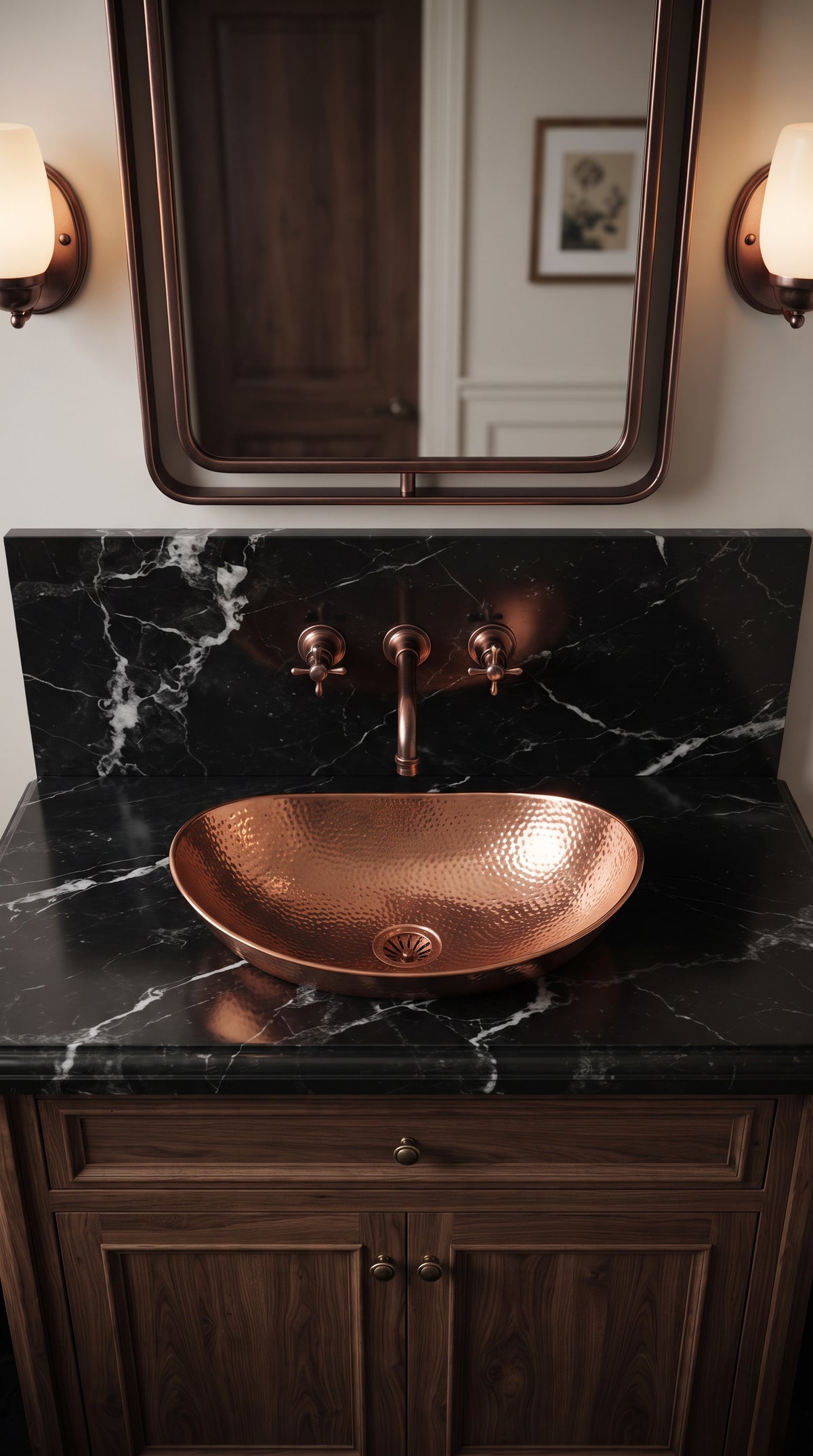 Hammered copper vessel sink on black veined marble, paired with a wall-mounted copper faucet beneath a rectangular mirror.