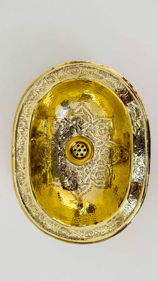 a gold plate with a decorative design on it