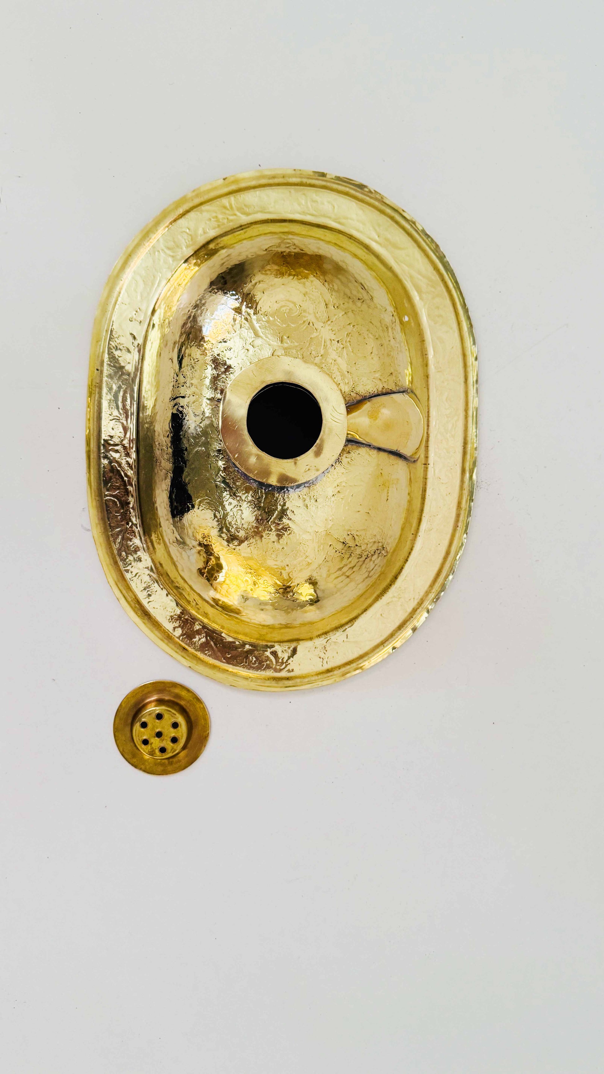 a gold plate with a button on it