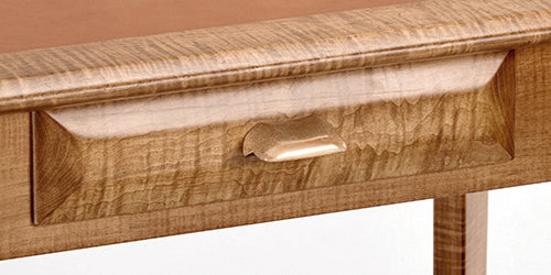 Wooden drawer with a handle on a wooden surface
